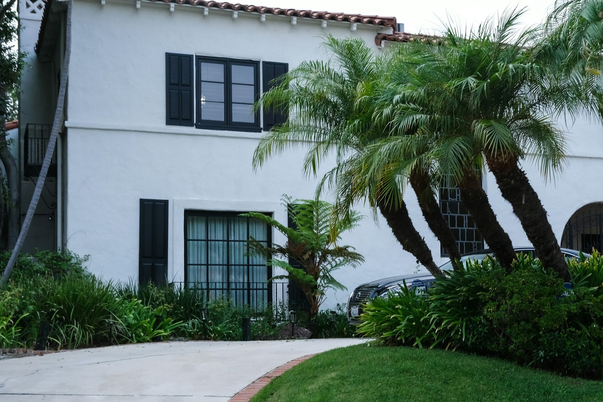 Stucco home exterior with palm trees and desert landscaping, Anaheim