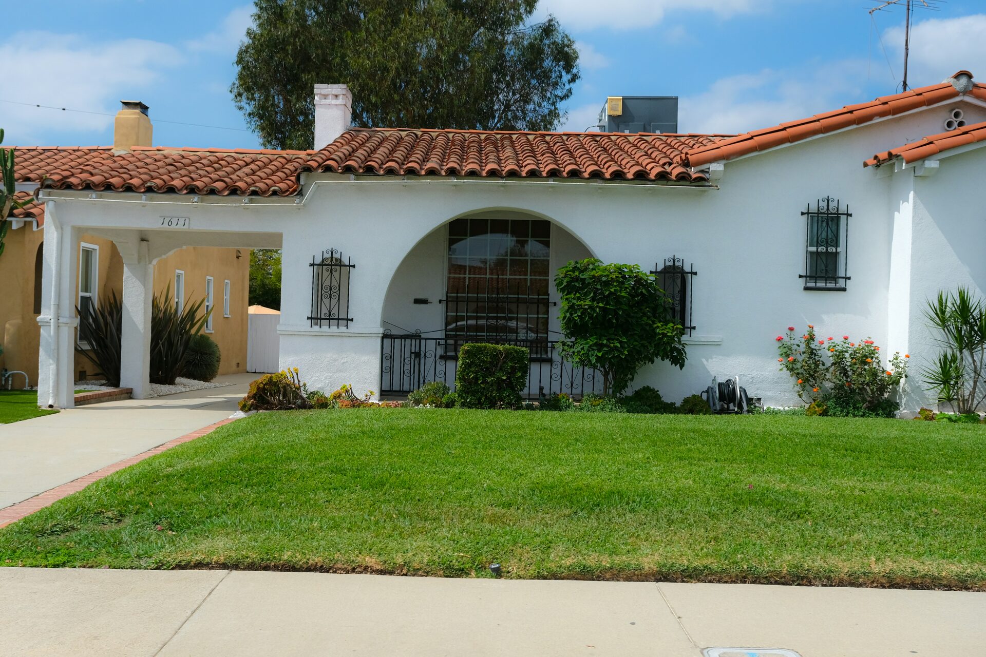 White stucco Mediterranean-style home with red clay tile roof, Orange County